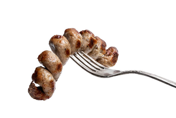 istock Grilled spiral sausage on a fork isolated on white 1308907434