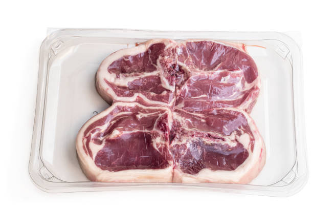 istock Raw lamb chops in vacuum package isolated on white 1308907658