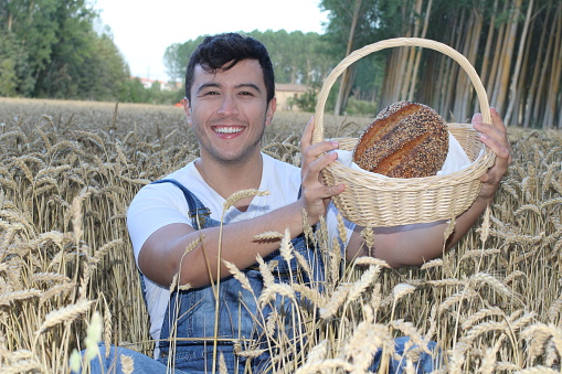 Young farmer baking bread with fresh ingredients.