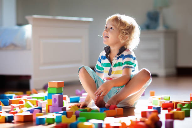 istock Child playing with colorful toy blocks. Kids play. 1308908626