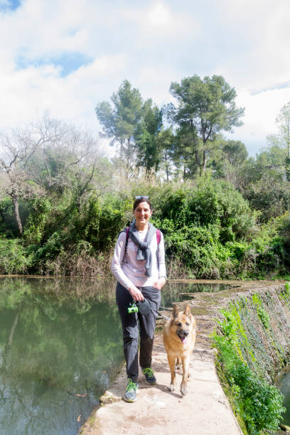 istock Cheerful woman walking her dog 1308909418