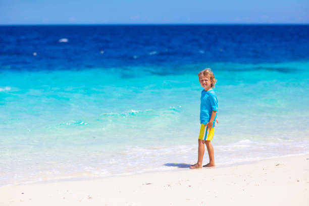 istock Kids playing on beach. Children play at sea. 1308909705