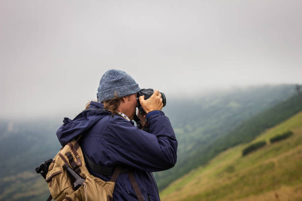 istock Hiking man photographing landscape at mountains 1308909834