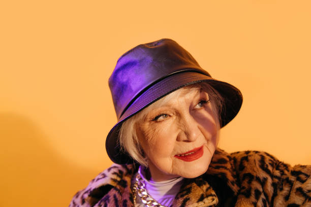 istock Woman with red lips squints in the sun while posing at the studio 1308910202