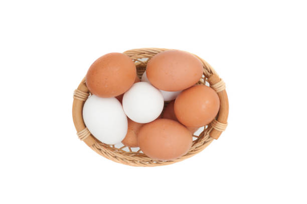 istock Eggs in wicker basket close up isolated on white background 1308911590