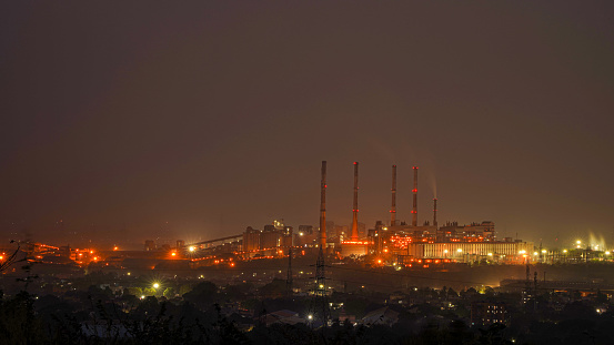 Night urban landscape with an industrial complex