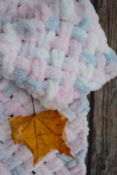 istock Light fluffy baby blanket on dark wooden background 1308913274