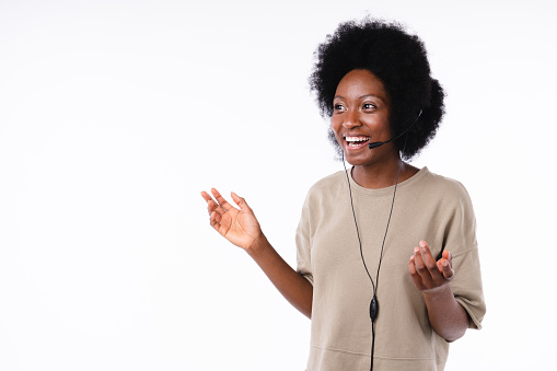 Talking cheerful african teen girl IT support worker isolated over white background