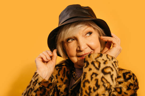 istock Female looking away while coquettish wearing hat and fur coat 1308914711