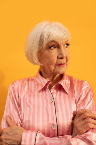 istock Woman keeping hands crossed and has wise expression, while looking away 1308914723