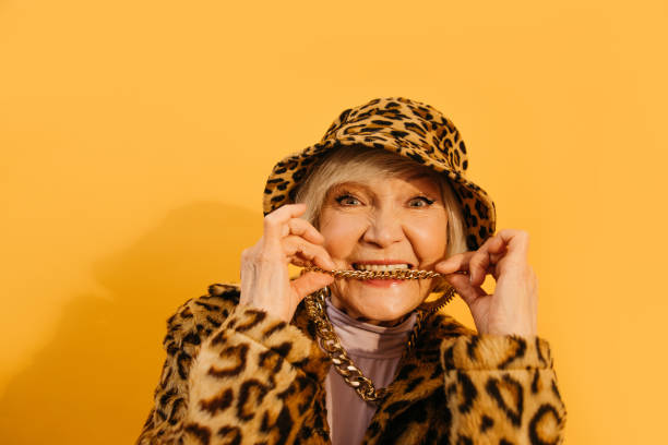 istock Senior woman bites her neck chain while looking at the camera 1308915258