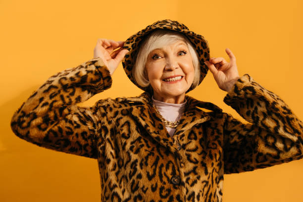 istock Woman wearing total leopard look flirtatiously adjusting his hat 1308915263