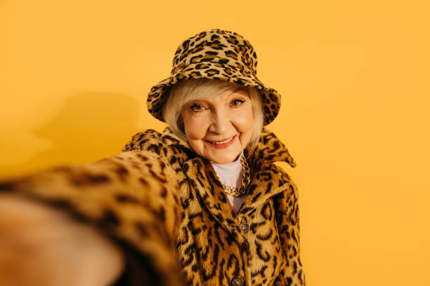 istock Woman wearing total leopard look taking selfie while spending time at the studio 1308915267