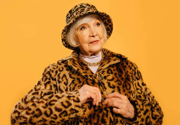 istock Woman demonstrating total leopard clothes while button up a fur coat 1308915269