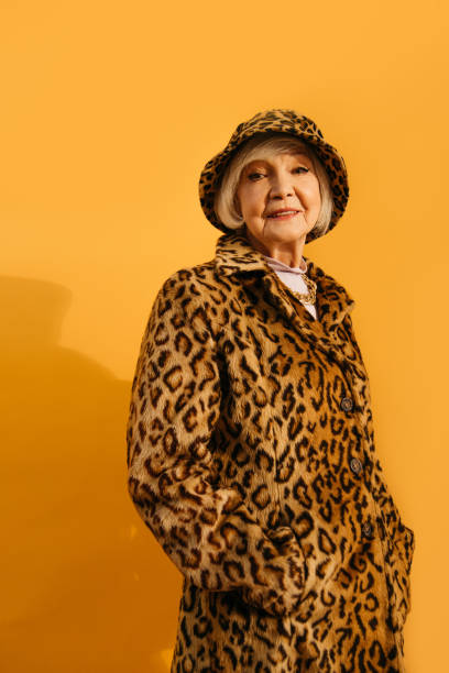Woman looking a the camera while keeping hands in her pockets