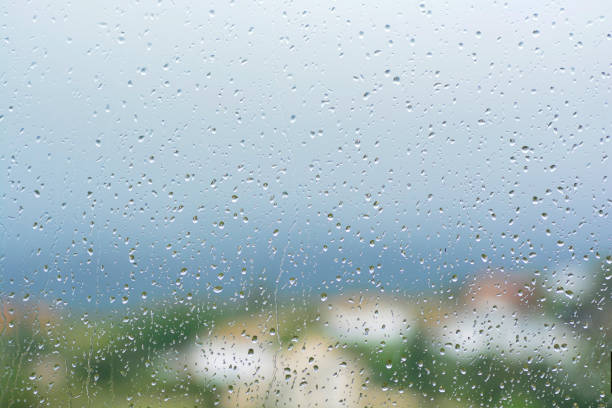 istock Raindrops on a window texture. Pure blue fresh clean. Window view background screensaver. Place for text banner. Drops after rain wet sunny day wallpaper silence calm summer freshen up 1308915807