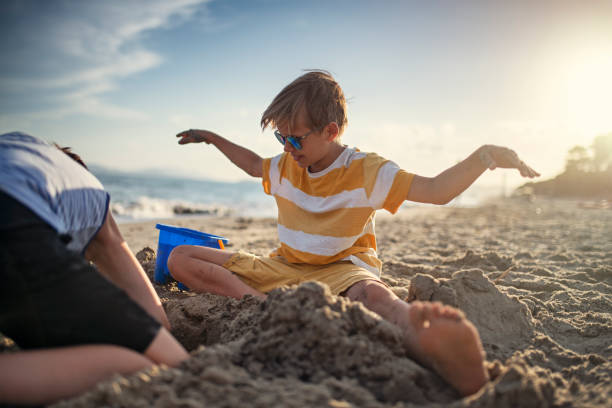 istock Brothers and sister having fun on the beach 1308918534