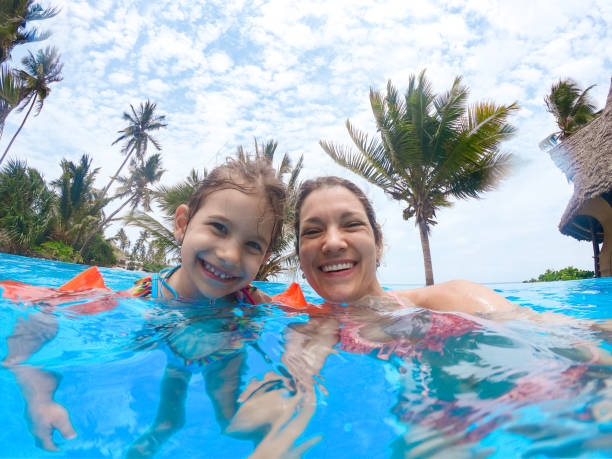 istock Mother and daughter enjoying beach vacation 1308918705