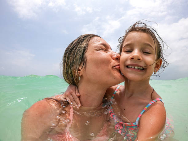 istock Mother and daughter enjoying beach vacation 1308919644