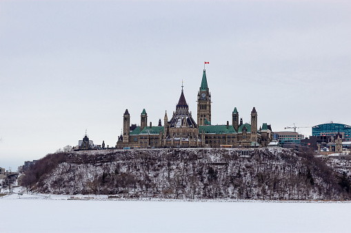 View of Canadian Parliament from the riverbank on a clear winter's day