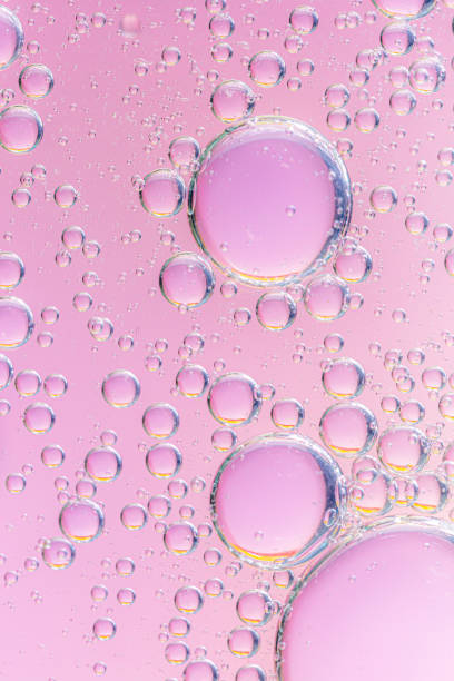 istock oil with bubbles on coral background. Pink Abstract space background. Soft selective focus. macro of oil drops on water surface. copy space. air bubbles in water, 1308922061