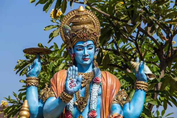 Photo of Detail stone statue in indian hindu temple on blue sky background