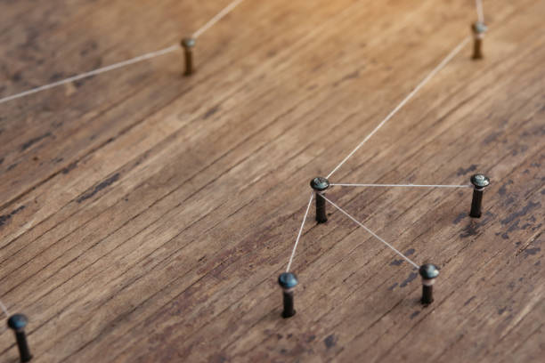 istock Network connected with yarn white on plank wood 1308926110