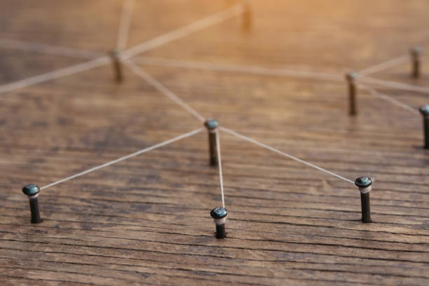 istock Network connected with yarn white on plank wood 1308926954