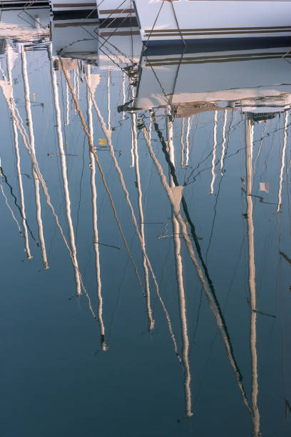 istock Reflection of masts in the water. 1308930841