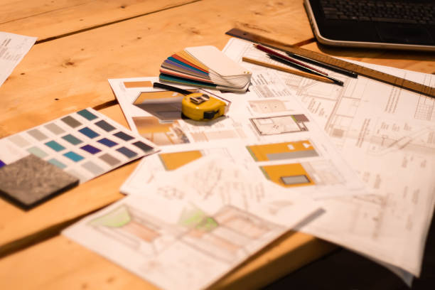 istock Blueprints and plans of a construction project with architect's tools on a wooden work table. 1308934253
