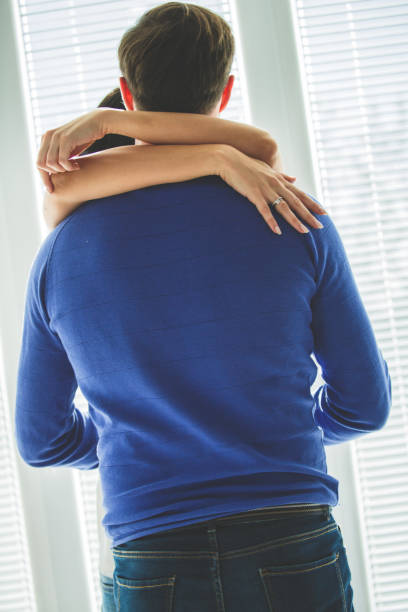 istock Woman wrapping her arms around her husband while sharing moments of affection 1308935247