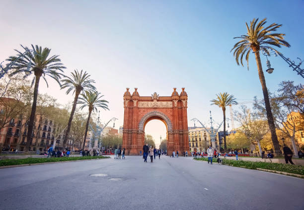 Barcelona, Arc de Triomf, Spain Barcelona, Spain - March 24, 2021: Tourists around the Arc de Triomf at sunset arc de triomf barcelona stock pictures, royalty-free photos & images