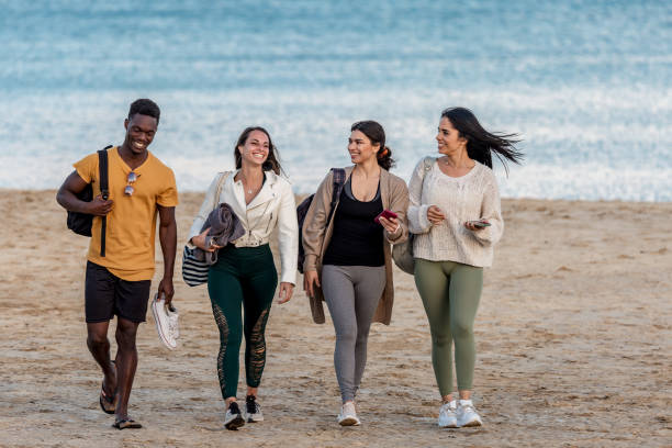 istock Cheerful diverse friends walking on beach together 1308935974
