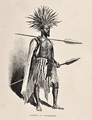 Full-length portrait of an indigenous African man of the Unyanembi tribe in Africa in 1870s. The native wears a feather headdress and carries spears. Illustration published 1891. Source: Original edition is from my own archives. Copyright has expired and is in Public Domain.