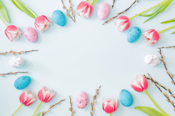 istock Flat lay easter composition with pink tulips and eggs on color background 1308936963