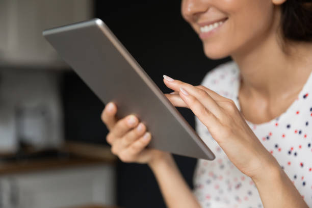 istock Happy young lady touch sensor screen of digital pad 1308937347