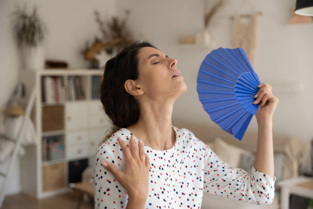 istock Exhausted young housewife suffer from extra hot temperature wave herself 1308937380