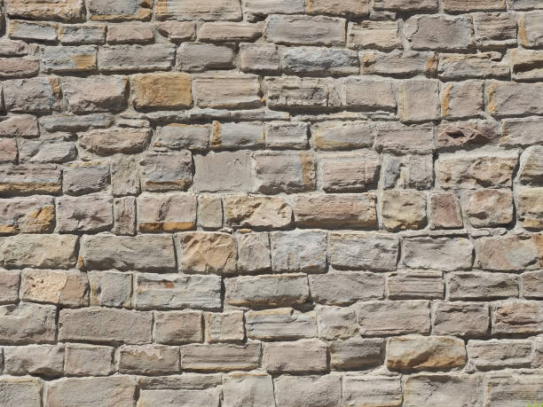 istock A wall with rough masonry of different sizes illuminated by sunlight. Not seamless texture 1308938118