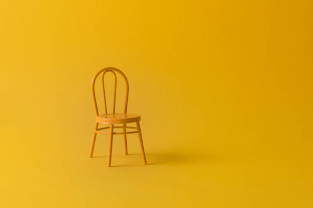 istock Vintage yellow chair on a yellow background. 1308940319