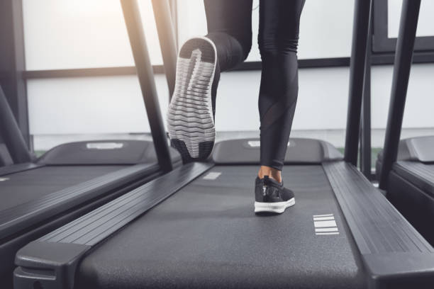 istock Legs woman running on treadmill. 1308942563