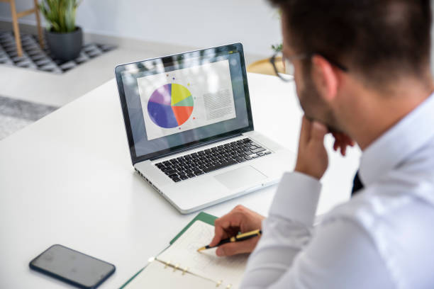 istock Businessman sitting at desk and working on his computer 1308942641