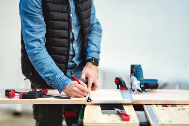 istock a man working with equipment on a wooden table in his backyard 1308944316