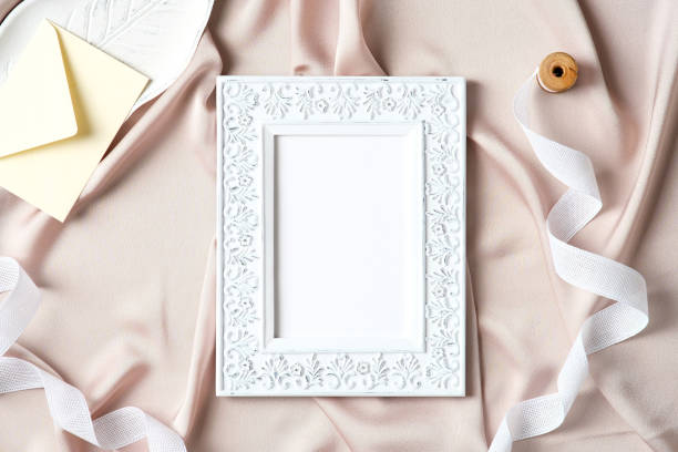 istock Photo frame mockup and female accessories on fabric background. Flat lay, top view, copy space. Boho style. 1308944546