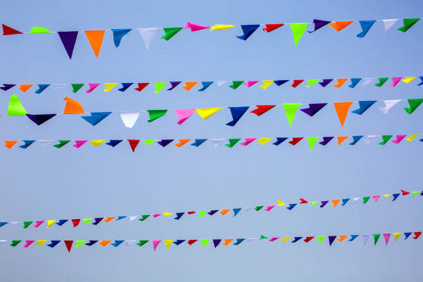 istock triangular festive multi-colored flags are suspended on a tight rope against the background of the sky, nobody. 1308946966