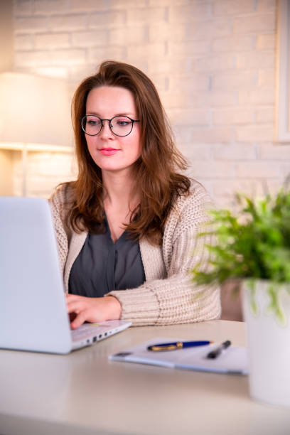 istock Woman working from home with white laptop computer. 1308947759