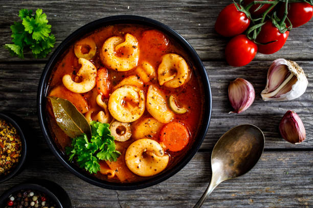 istock Tomato soup with noodles on wooden background 1308947826