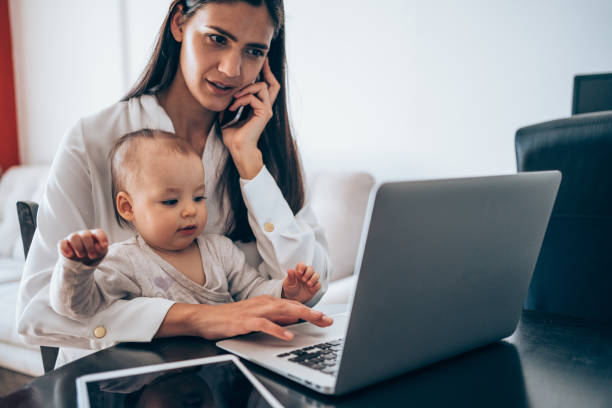 istock Mother and baby working at home. 1308948109