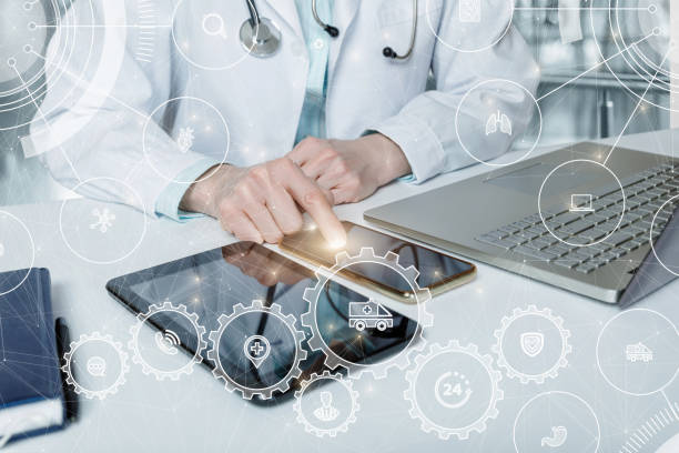 istock Doctor works with mobile devices on the Internet in the office. 1308948443