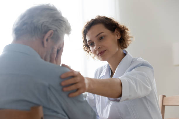 istock Caring young doctor support comfort unhappy mature patient 1308949117