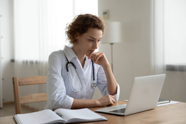 istock Pensive female GP work on laptop thinking 1308949161